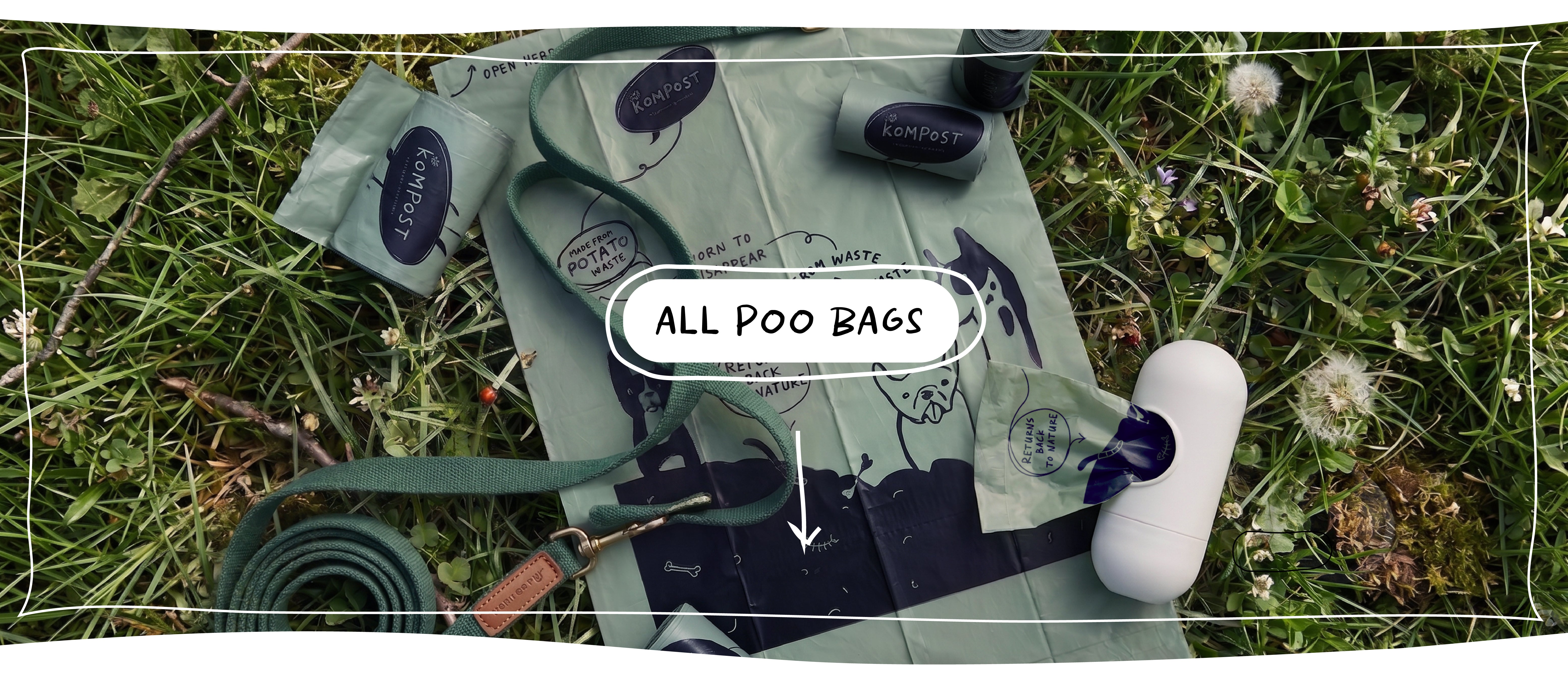 Kompost compostable dog poo bags made from waste potato starch with dog lead and bag dispenser on grass.